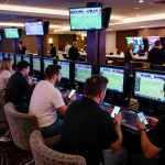 Engaged sports bettors analyzing odds at https://da88at.com/ in a vibrant casino setting