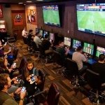 Engaged bettors strategizing sports bets at TX88, showcasing excitement and dynamic betting activities.