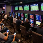 Sports betting enthusiasts engaging at keonhacaii88 lounge with live odds displayed