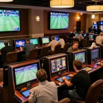 Exciting betting scene at 188bet, showcasing enthusiastic bettors engaging with interactive screens