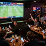 Experience NK88 sports betting excitement with patrons actively placing bets while enjoying live games.